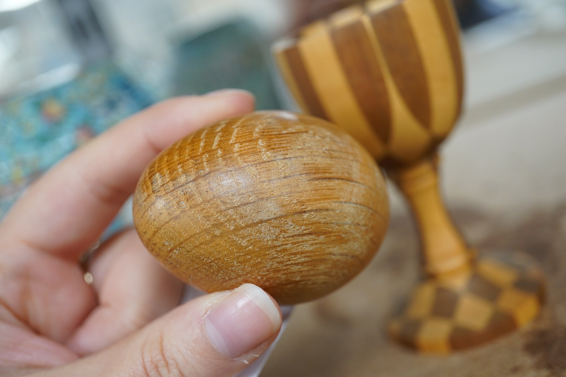 A Linley apple and holly wood egg cup with an oak egg, overall 14cm high. Condition - good